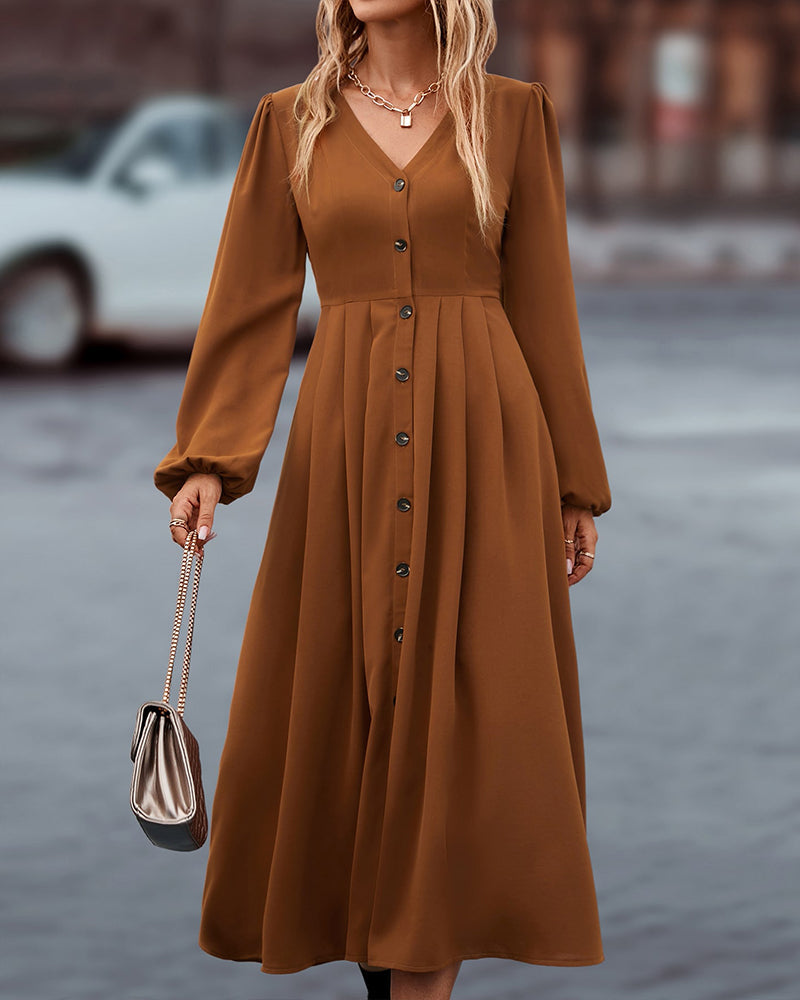 Midi-jurk met elegante knopen en lange pofmouwen, een must-have voor elke garderobe