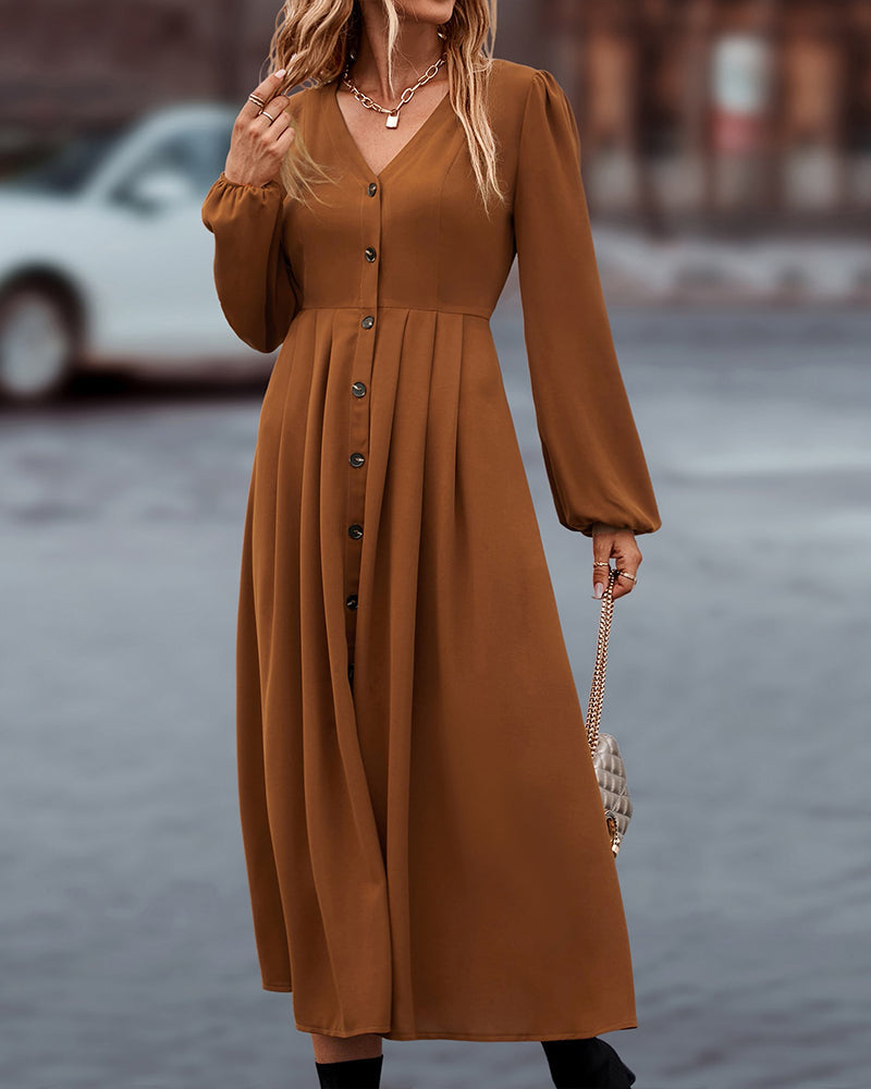 Midi-jurk met elegante knopen en lange pofmouwen, een must-have voor elke garderobe